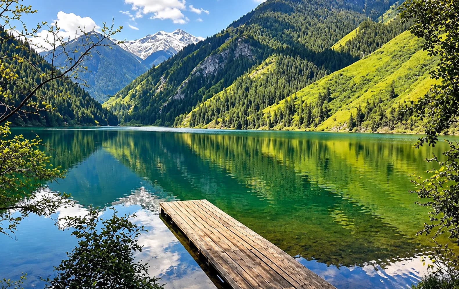 A wooden dock on the turquoise waters of a Kolsai Lake, surrounded by forested mountains