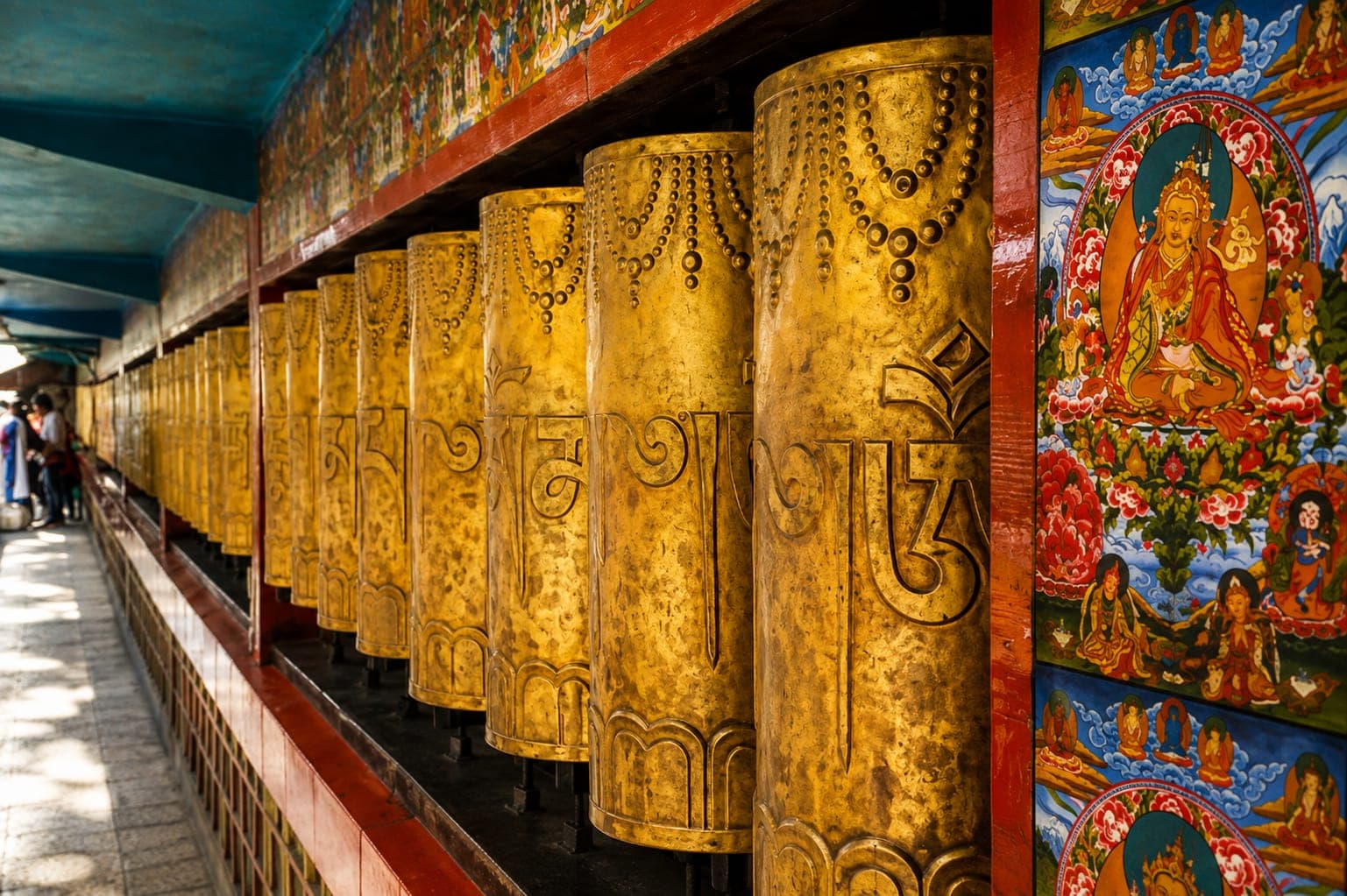 Golden prayer wheels at a Mcleodganj monastery