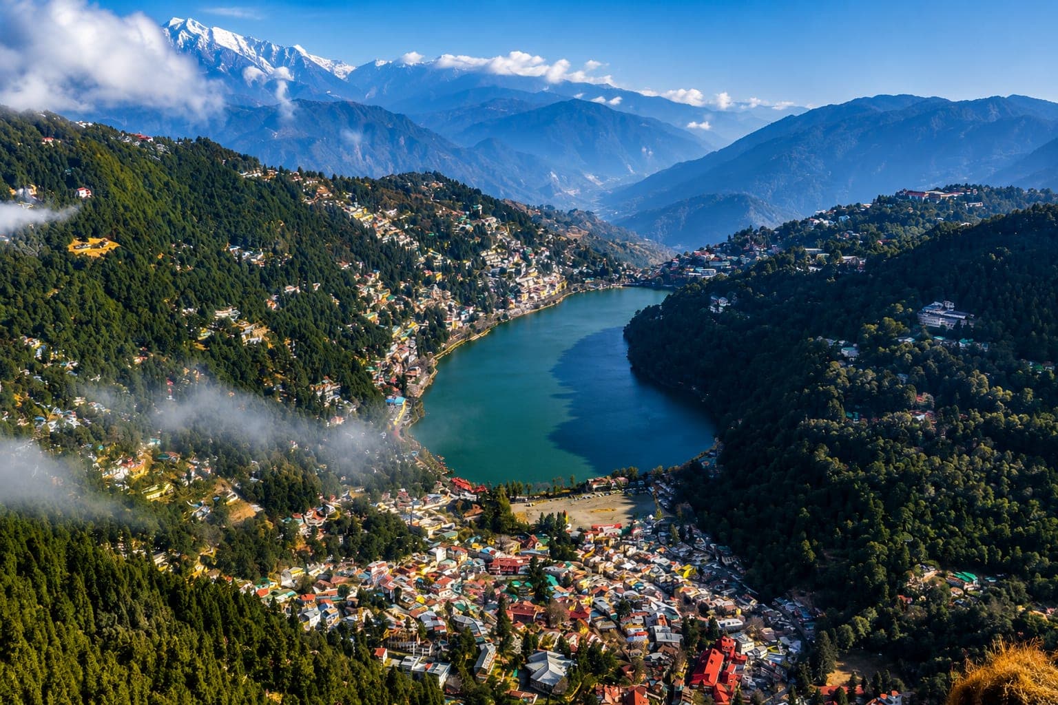Aerial view of Naini Lake and Nainital town with the Himalayas behind, in Kumaon, Uttarakhand